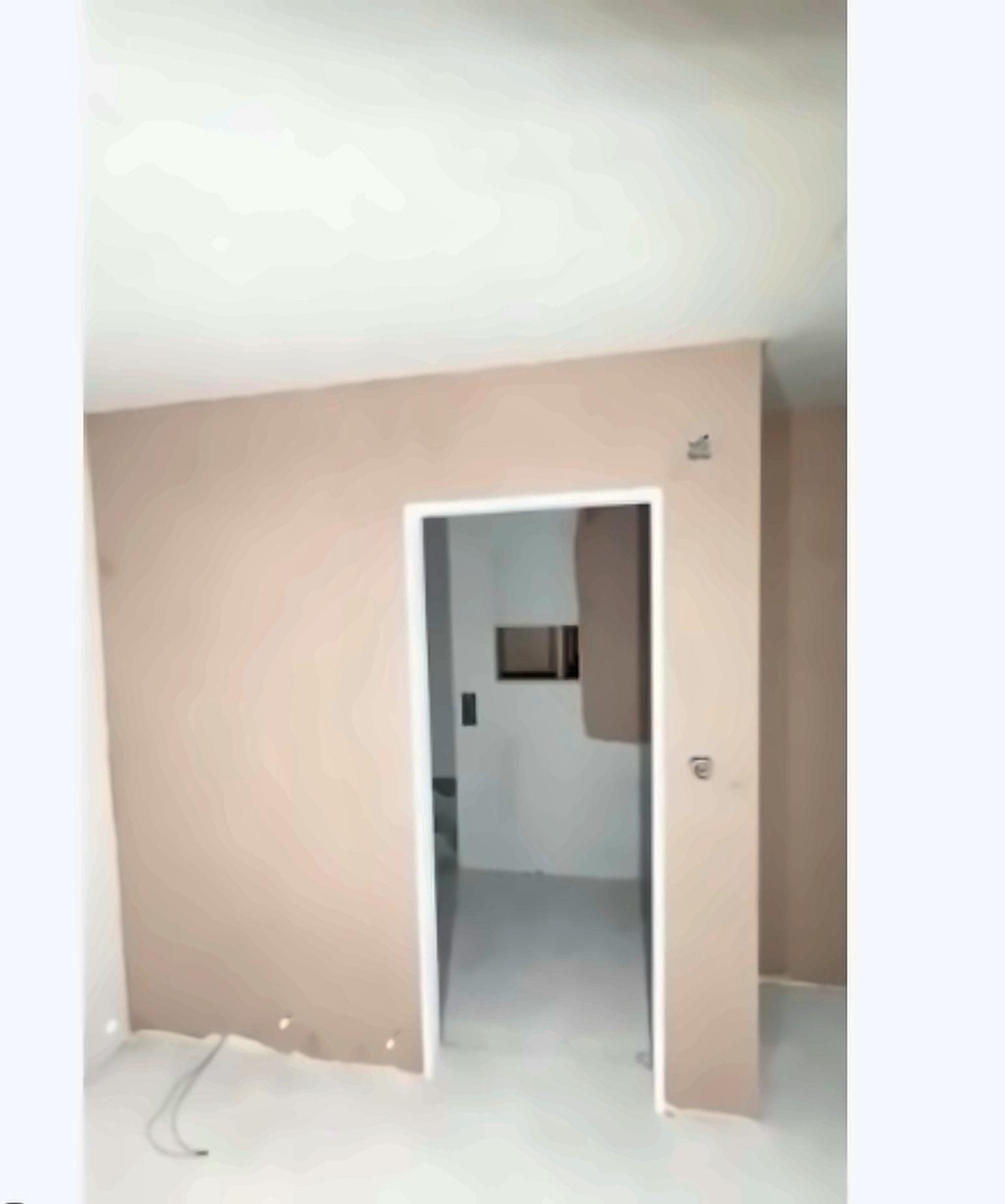 Fresh plaster skim on a doorway wall in a SE London renovation, ready to dry before painting.